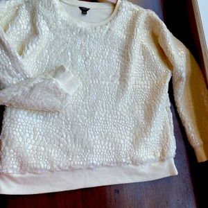 Rich, creamy colored sweater with the softest and coolest design!